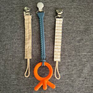 ITZY RITZY 3 pacificer straps - 2 cloth, 1 silicone approx. 9.5” ea plus teether